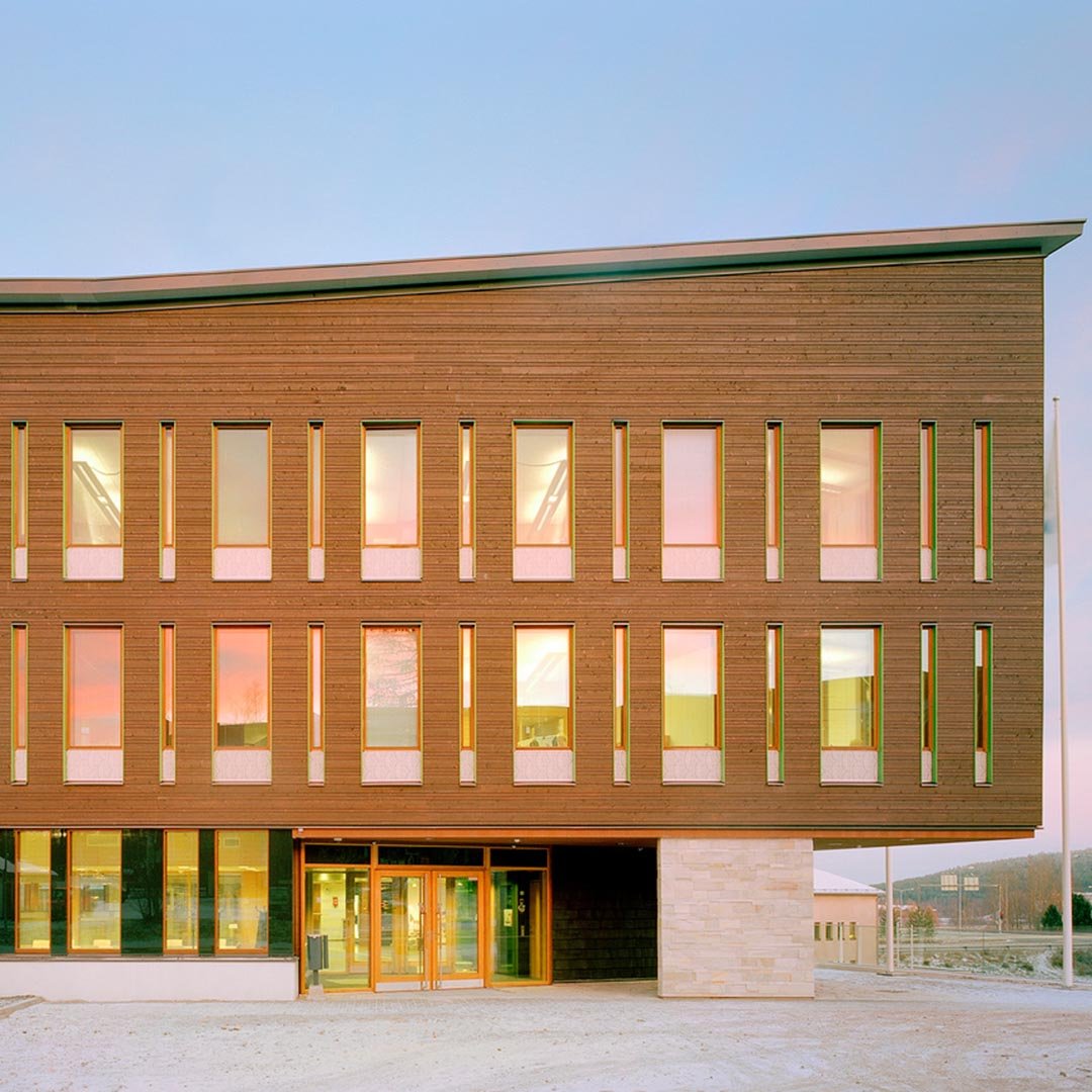 The image shows the beautiful facade architecture at the entrance of a timber building.